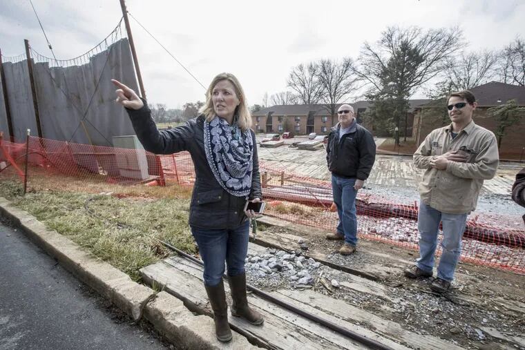 Cheryl Wardle, left, David Mano, center, and Bill Wardle, Cheryl’s husband, stand in front of a Sunoco Pipeline drilling site on Shoen Road in Exton that has been idle since private water wells went bad in July.
