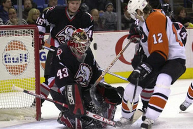 Teammates now, but in 2004 game Simon Gagne (right) could not beat Martin Biron in Buffalo&#0039;s goal.