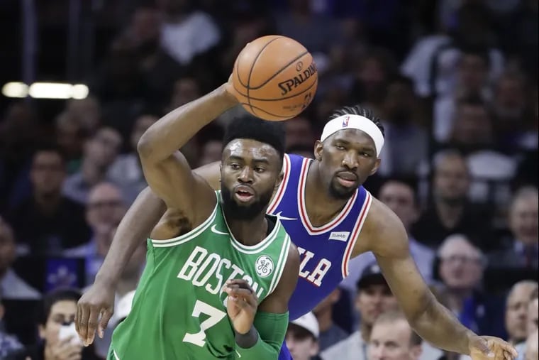 The Celtics’ Jaylen Brown (shown going after the ball against the Sixers’ Joel Embiid during an October game) could be out for the first game of the series.