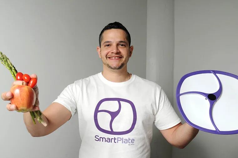 Anthony Ortiz, founder of Fitly, displays his invention. The SmartPlate analyzes the contents of a meal by algorithm. ( CLEM MURRAY / Staff Photographer )