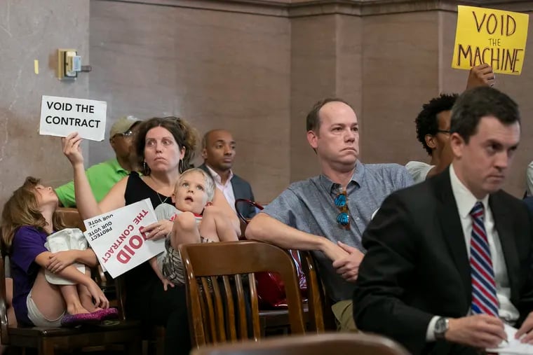 Activists sit inside a courtroom at Philadelphia City Hall where the board of elections decided to move forward with the current contract for new voting machines on Thursday, Aug. 15, 2019. The vote came days after the city’s legal department notified elections officials that the vendor had failed to disclose its lobbying activities.