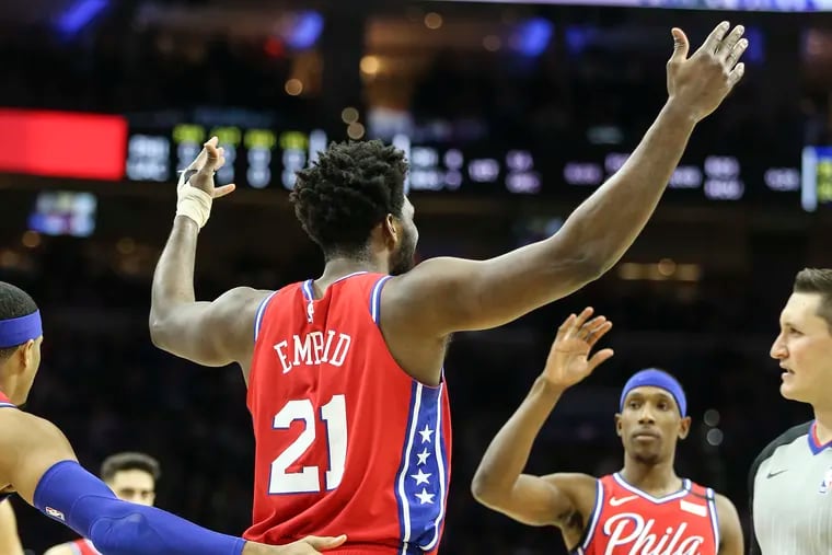 The Sixers' Joel Embiid reacts to cheering fans after his first basket against the Clippers.