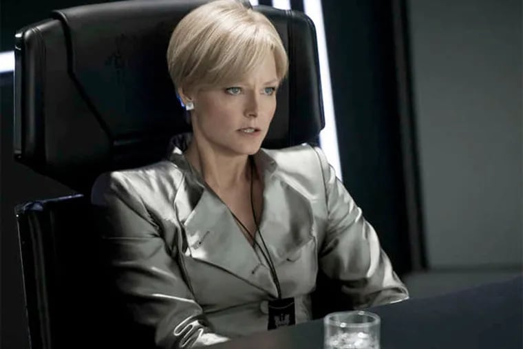 Jodie Foster plays Secretary of Defense Delacourt, protector of Elysium, a refuge in space for the rich and elite, from Earth's undesirables.