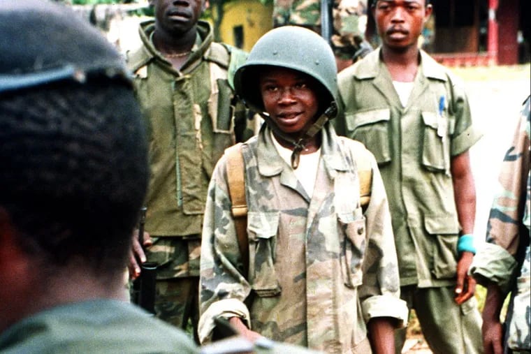 In a 1992 file photo, a young ULIMO-K militia soldier in Liberia listens to his commanding officer. Not pictured is Mohammed Jabateh, a 51-year-old East Lansdowne man accused of committing war crimes as a leader of the militia between 1989 and 1996.