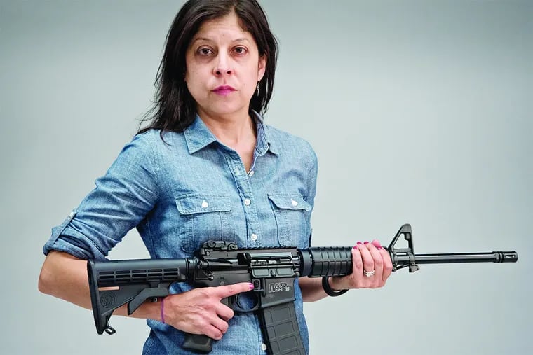 Daily News columnist Helen Ubinas with a newly purchased AR-15 semiautomatic rifle on Monday.
