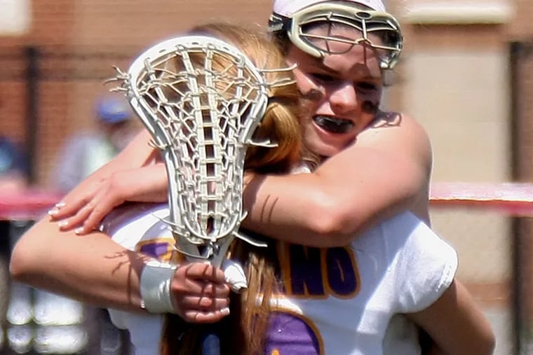 Garnet Valley senior Haley Warden hugs teammate Nova Ward (back to
camera) after the Jaguars defeated Harriton, 16-12, Saturday in a PIAA
state girls’ lacrosse quarterfinal at West Chester East. (Lou Rabito/Staff)