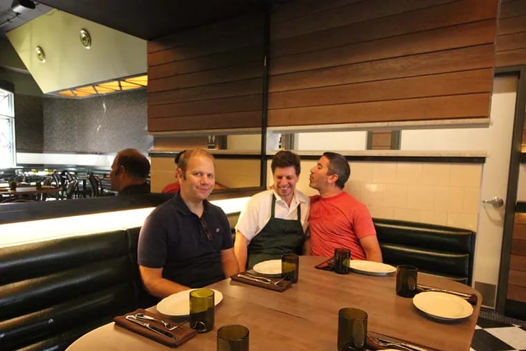 At a corner table at Abe Fisher, co-owner Steve Cook (left) plays straight man while business partner Michael Solomonov whispers sweet nothings in the ear of chef Yehuda Sichel.
