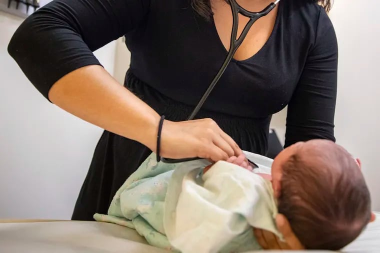 Jasmine Saavedra, a pediatrician at Esperanza Health Centers whose parents emigrated from Mexico in the 1980s, examines Alondra Marquez, a newborn baby in her clinic in Chicago.