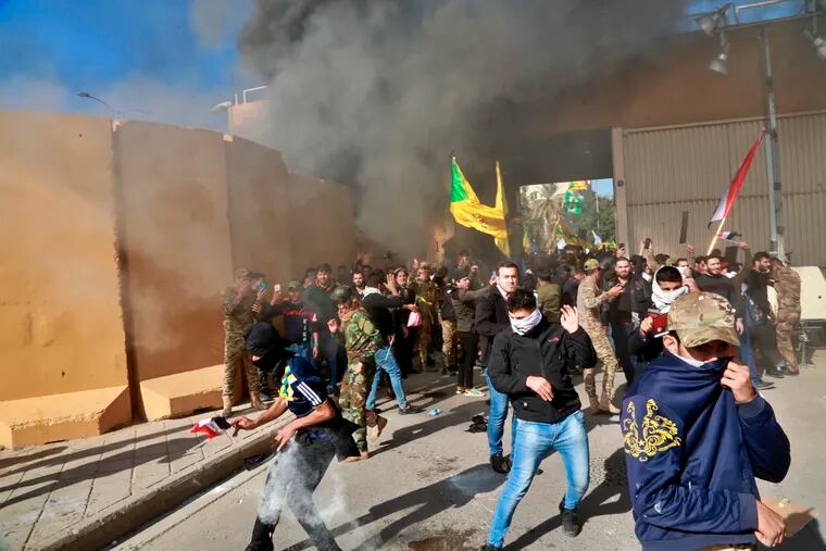 U.S. soldiers fire tear gas towards protesters who broke into the U.S. embassy compound in Baghdad, Iraq, on Tuesday.