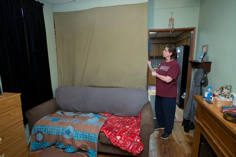 In Christine Soder's Frankford living room, a curtain hangs where a wall once stood. A leak in the upstairs bathroom damaged the wall, and Soder opted to remove it and hang a curtain in its place. Many homeowners across the city face problems inside their homes, and city officials are hoping the loan program can help them.