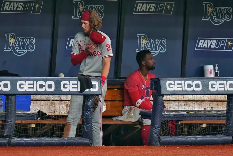 Alec Bohm, left, and Andrew McCutchen didn't hide their emotions in the Phillies' dugout after Saturday's loss.