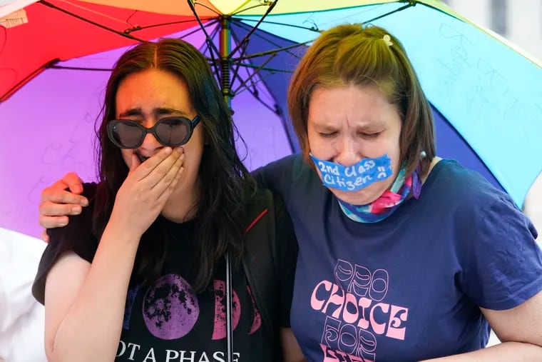 Abortion-rights activists react after hearing the Supreme Court decision on abortion outside the Supreme Court in Washington on Friday.