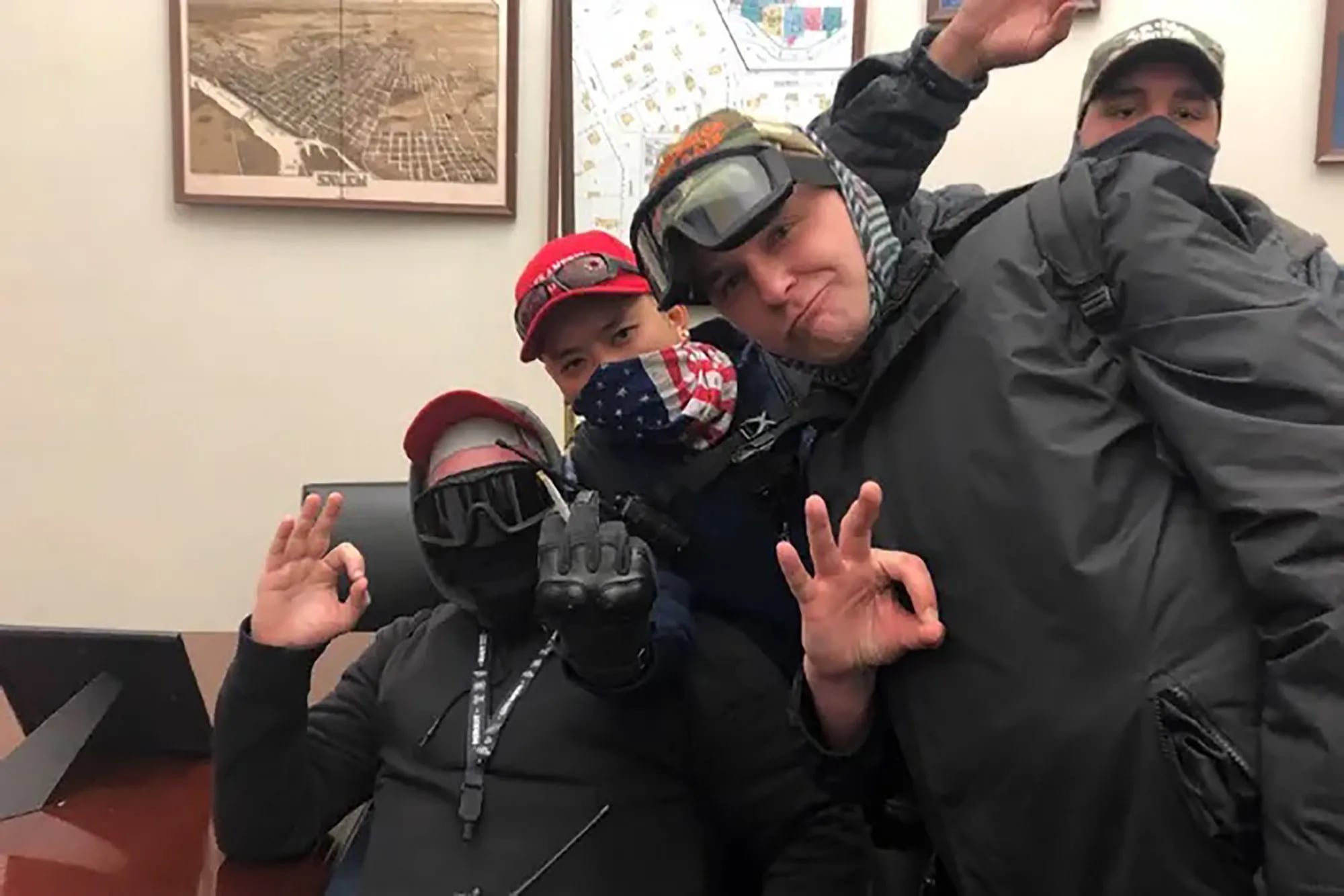 From left, Philly Proud Boys Brian Healion, Freedom Vy, Zach Rehl, and Isaiah Giddings pose for a photo on Jan. 6 in the office of Sen. Jeff Merkley (D., Ore.)