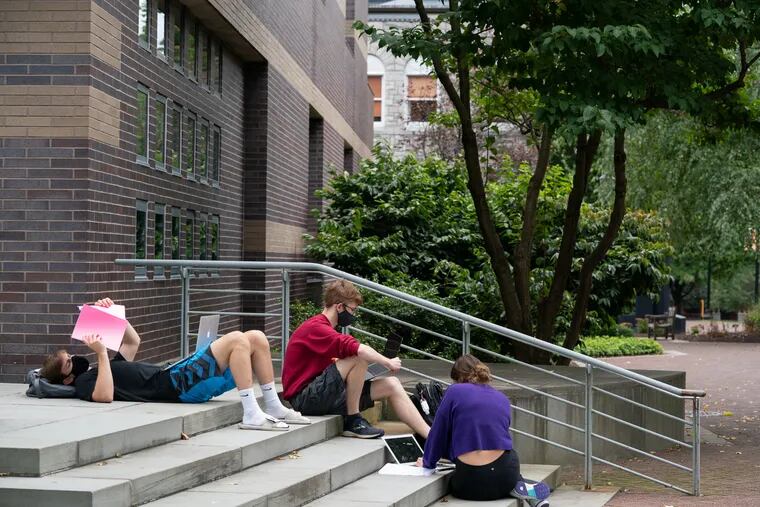In this 2020 photo, Ursinus College students (left to right) Dylan Crammer, Nick Pickar, and Shay Henes do group work during a break in class.
