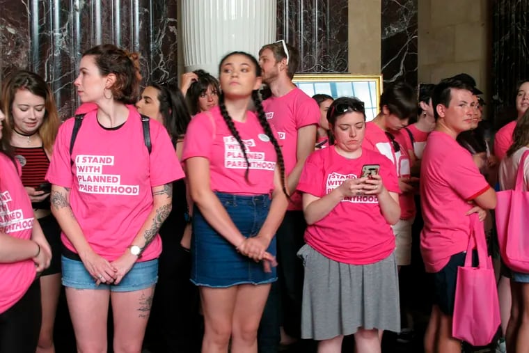 Planned Parenthood protesters hold a "stand-in" at the Louisiana Capitol, in opposition to legislative passage of a bill that would ban abortion as early as six weeks of pregnancy, on Thursday, May 30, 2019, in Baton Rouge, La. A Louisiana case dealing with abortion restrictions is headed to the Supreme Court.