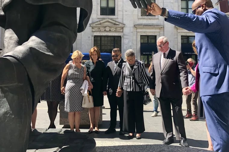 Mayor Jim Kenney stands with city officials and members of a committee that released a report detailing changes the city has made over the past year related to diversity, equity and inclusion. A news conference announcing the report concluded with a moment of silence at the statue of Octavius V. Catto outside City Hall.