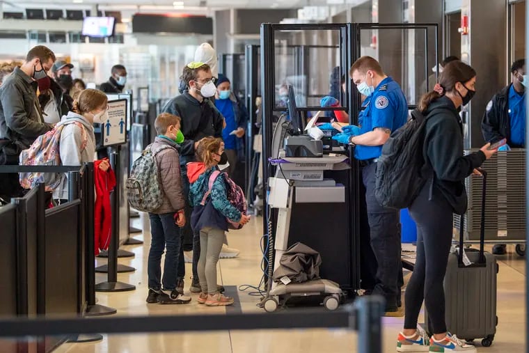 Travelers go through TSA security checkpoints at Philadelphia International Airport on Dec. 21.