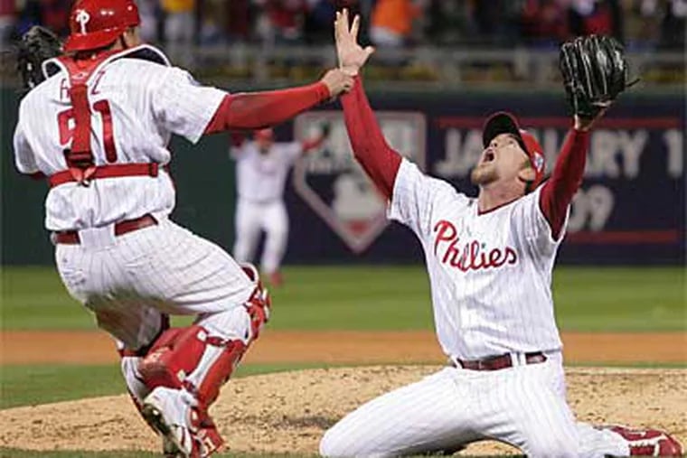 Phillies closer Brad Lidge drops to his knees and waits for Carlos Ruiz after getting the final out in Game 5 of the World Series against the Rays. (Jerry Lodriguss / Staff Photographer)