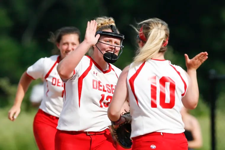 Delsea High senior Diana Parker (center) celebrates a strikeout with teammate Kaylin Power (right) against Seneca High during the second round of the South Jersey Group 2 state tournament on Monday.