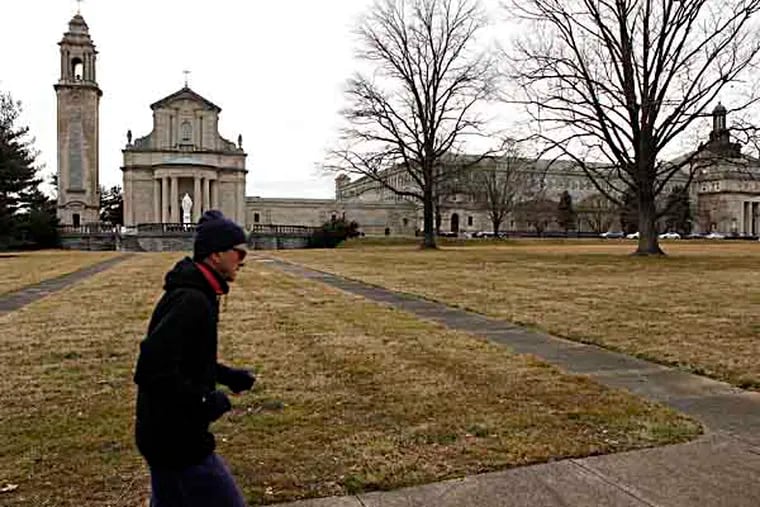 An unidentified man runs on the grounds of Saint Charles Borromeo Seminary off Lancaster Avenue near City Avenue. March 7, 2013. ( MICHAEL S. WIRTZ / Staff Photographer ).