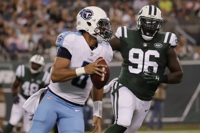 Tennessee quarterback Marcus Mariota (8) runs while under pressure from Jets defensive end Muhammad Wilkerson during a preseason game.