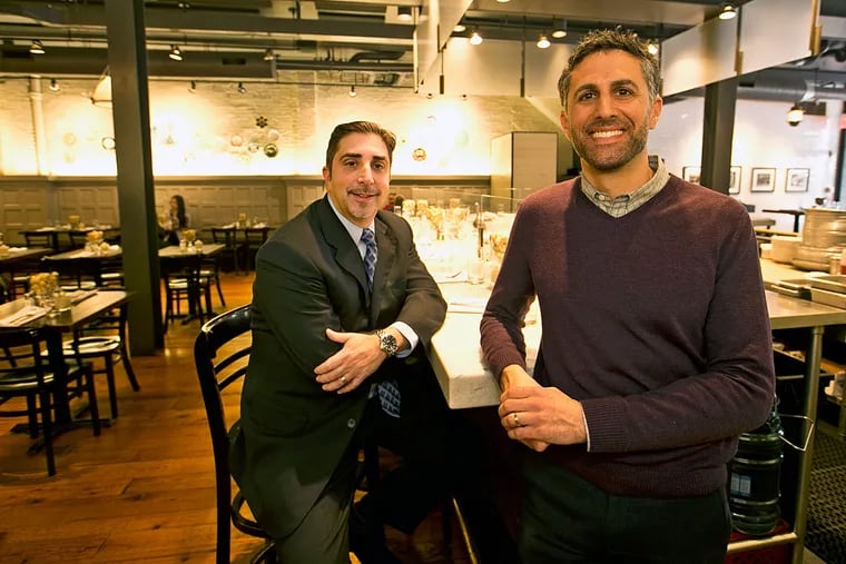 At Sansom Street Oyster House, Dan Hernandez, left, and owner Sam Mink make sure that managers, servers and oyster shuckerswill get a unique benefit, a 401-K plan with a company match.