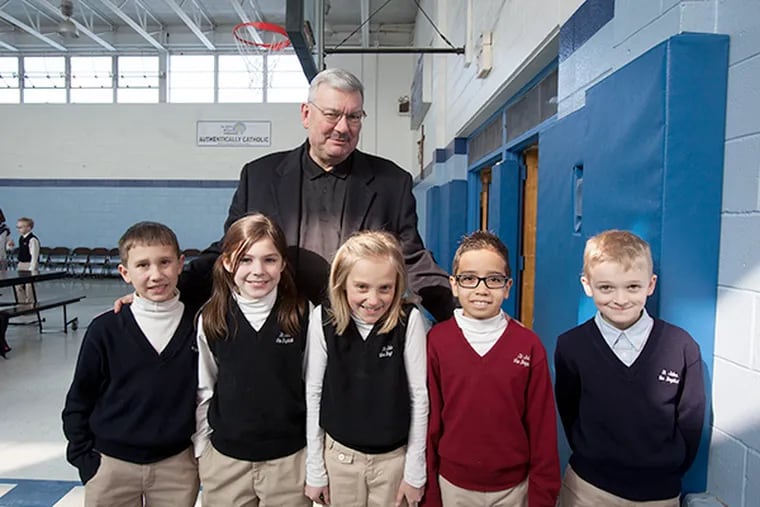 St John the Baptist Catholic School in Ottsville PA is small by any means with a total of 78 students. It was one of the 45 elementary schools slated for closure but the decision was appealed and the school remains open. Here, principal Michael Patterson shares a moment with 3rd graders at lunchtime. Left to right, Gavin Reshetar, 8, Grace Altier,9, Patterson, Emily Vinal, 8, Manny Santos,9, Richie Lanning, 9. (ED HILLE / Staff Photographer )