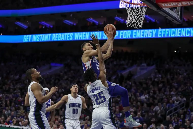 Sixers guard Ben Simmons drives to the basket and draws a foul in the fourth  quarter of Tuesday's game against the Orlando Magic.