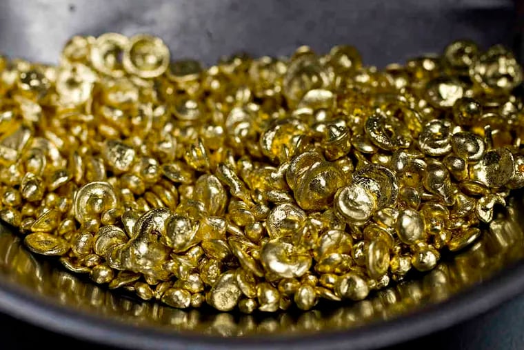 Pure gold casting grain, above, at a N.Y. jewelry store. Gold was at $1308.37 on Wednesday but could rise in a stock market pullback.
