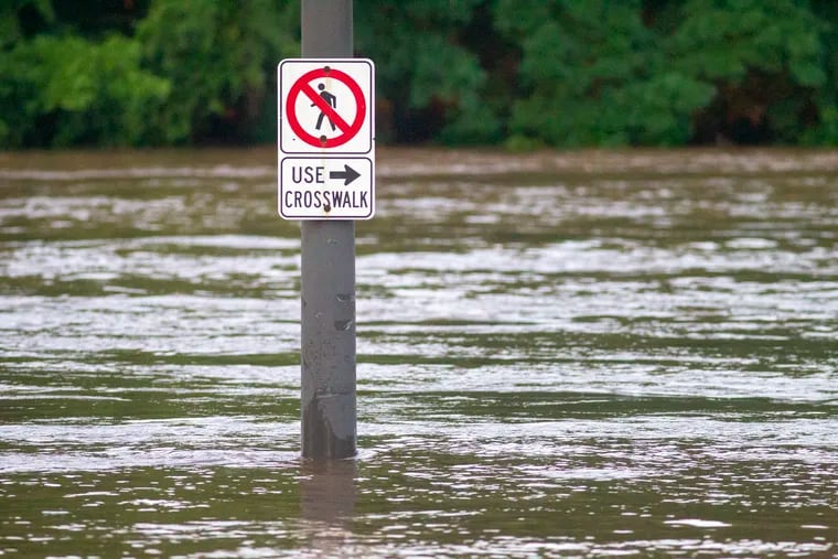 A sign post at Midvale and Kelly Drive on Wednesday is submersed after Schuylkill overflowed its banks, part of Isaias legacy. Unfortunately, the hurricane season has a long way to go.
