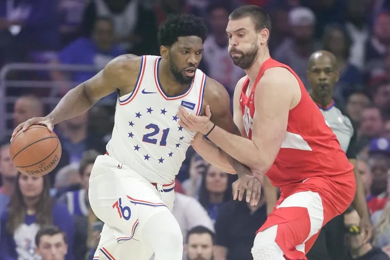 Sixers center Joel Embiid dribbles the basketball against Toronto Raptors center Marc Gasol during game six in the Eastern Conference playoff semifinals on Thursday, May 9, 2019 in Philadelphia.