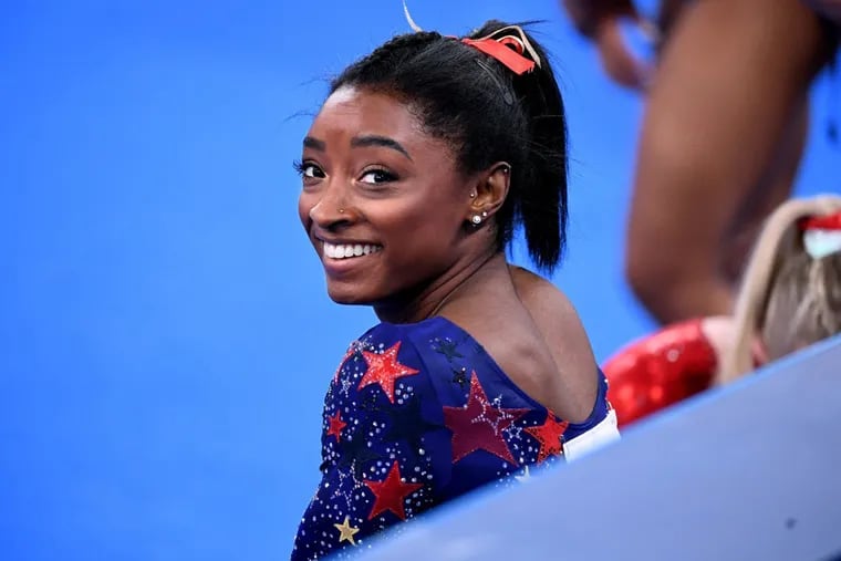 Simone Biles smiles between sessions in the women's team qualifying at the 2020 Tokyo Olympics in July. She and her teammates are now touring as Gold Over America, at the Wells Fargo Center Nov. 5.