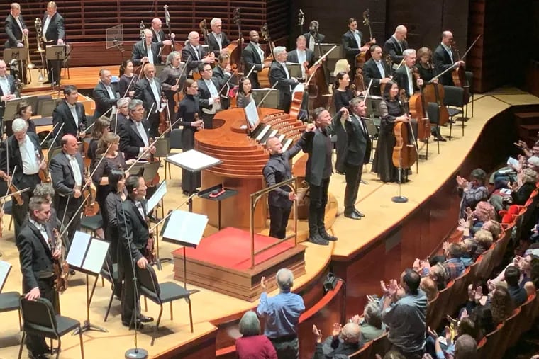 Conductor Yannick Nezet-Sequin, composer Nico Muhly, organist James McVinnie, and the Philadelphia Orchestra acknowledge audience applause for Muhly's new concerto.