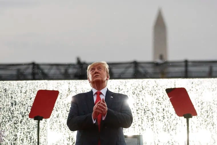 President Donald Trump looks up during the military flyovers at the Independence Day celebration in front of the Lincoln Memorial, Thursday, July 4, 2019, in Washington.