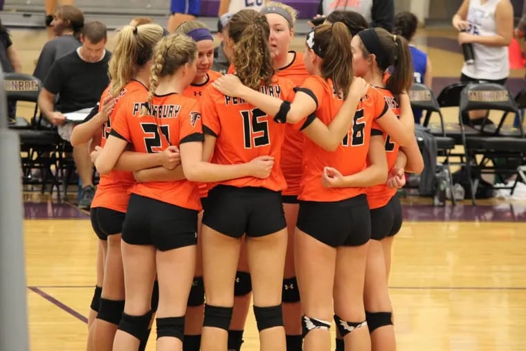The Pennsbury girls’ volleyball team huddles during a match. The Falcons opened the season 9-0.