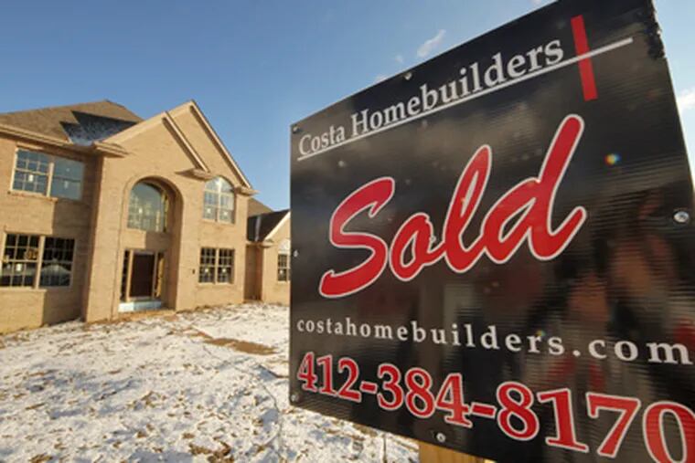 A sold sign is seen in front of a new home in Jefferson, Pa., Wednesday, Jan. 18, 2012. (AP Photo/Gene J. Puskar)