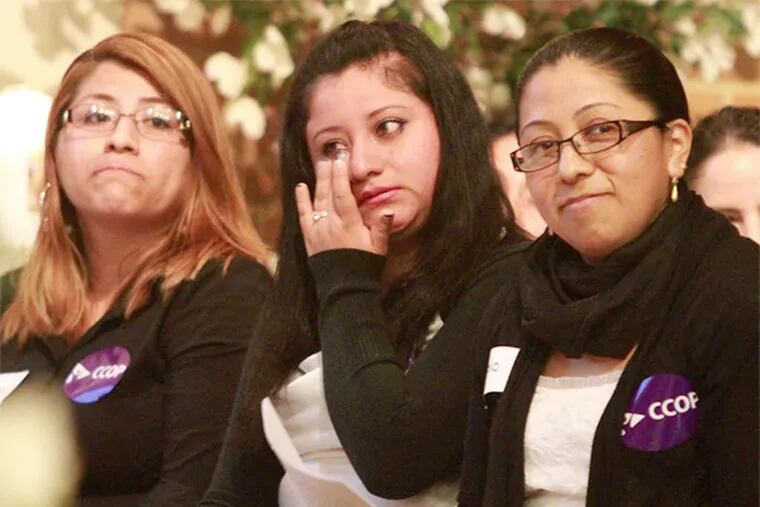 Alejandra Ruiz Medina (center) cries during a meeting at St. Joseph's Pro-Cathedral urging support for "driving privilege cards."