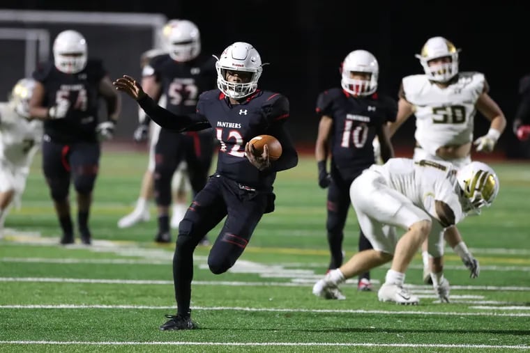 Imhotep Charter's Jalen Sutton-Christian runs for a long gain in last Friday night's 41-6 win over Bethlehem Catholic in a PIAA Class 4A football semifinal.