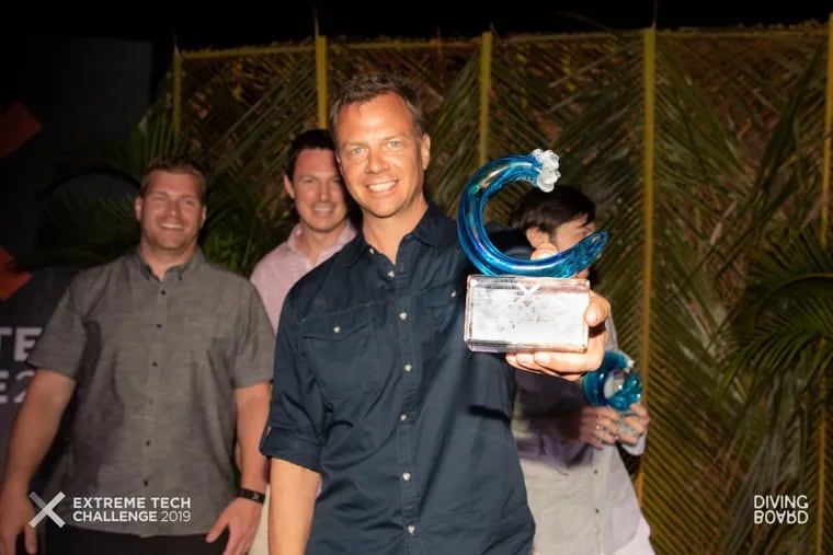 Tango cofounder Drew Lakatos hoists the trophy as winner of the Extreme Tech Challenge on Sir Richard Branson's Necker Island in April.