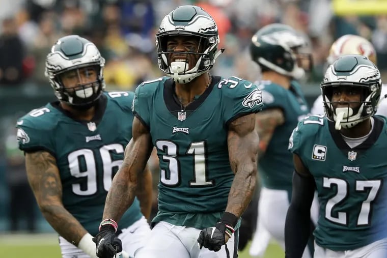 Eagles cornerback Jalen Mills reacts after a stop with teammates strong safety Malcolm Jenkins (right) and defensive end Derek Barnett (left) against the San Fransisco 49ers on Sunday, October 29, 2017 in Philadelphia. YONG KIM / Staff Photographer