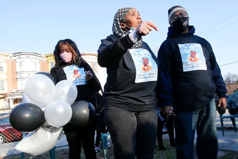 Former State Rep. Movita Johnson-Harrell (center), husband Yancy Harrell (right) and daughter Charlyne Johnson meet with family and friends during a balloon release and vigil at Wyalusing Park in West Philadelphia on March 8, 2021 for their son and brother, Donté Johnson, who was shot and killed in California on March 5.