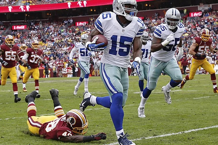 Dallas Cowboys wide receiver Micheal Spurlock leaves Washington Redskins strong safety Jose Gumbs on the turf while returning a punt during the first half on Sunday. (Alex Brandon/AP)