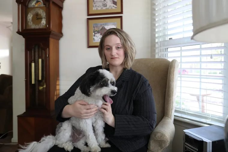 Krissy Houser, 41, has had chronic pain since a back injury in 2006. She is shown here with her dog, Mitzie.