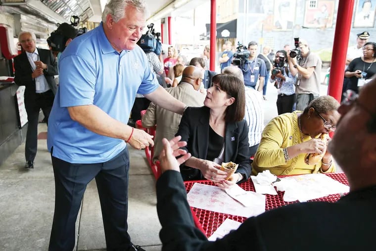 A delegation from Democratic National Committee comes to town for two days as Philly tries to sell itself for 2016 national convention. Congressman Bob Brady, left, talks with DNC CEO Amy Dacey, center, as they have lunch at Pat's Steaks in South Philadelphia on August 13, 2014.