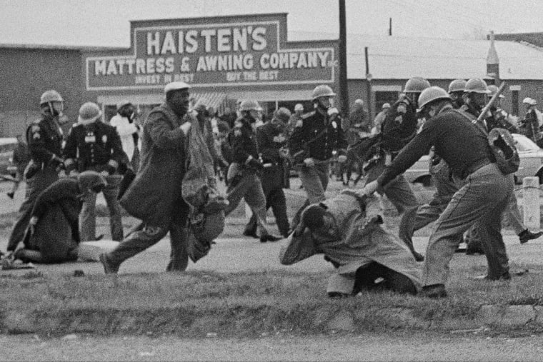 State troopers swing billy clubs to break up a civil rights voting march in Selma, Ala., March 7, 1965. John Lewis, chairman of the Student Nonviolent Coordinating Committee (in the foreground) is being beaten by a state trooper. Lewis, a future U.S. Congressman sustained a fractured skull. (AP Photo)