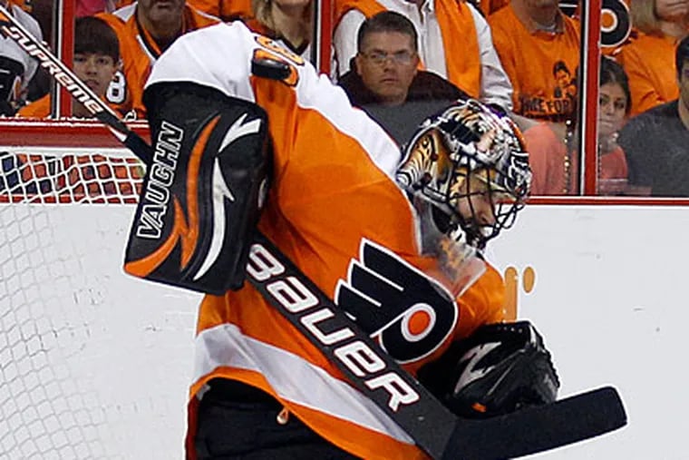 Flyers goalie Ilya Bryzgalov stops the puck on a Penguins shot during the second period. (Yong Kim/Staff Photographer)