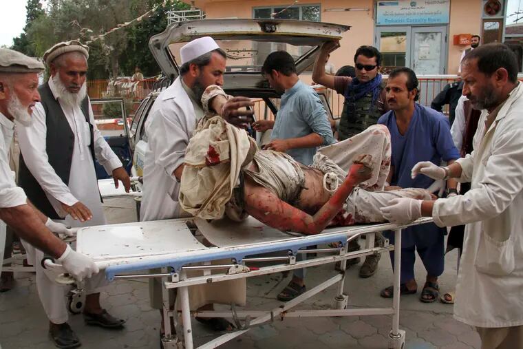 A wounded man is brought by stretcher into a hospital after a mortar was fired by insurgents in Haskamena district of Jalalabad east of Kabul, Afghanistan, Friday, Oct. 18, 2019. An Afghan official says at least several people have been killed during Friday prayers when a mortar fired by insurgents blasted through the roof of a mosque.