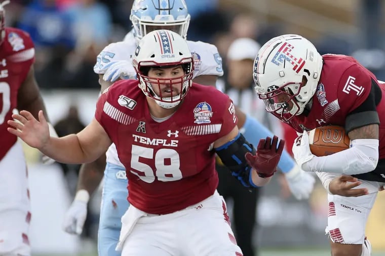 Temple center Matt Hennessy prepares to block as quarterback Todd Centeio  carries the ball during the Military Bowl against North Carolina in December.