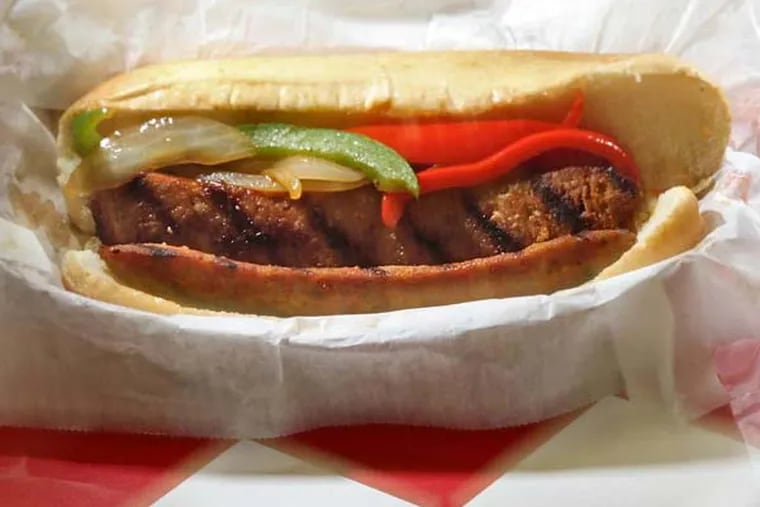 Italian hot sausage link with peppers and onions, with a pair of meatball sliders at Botto’s, 984 Boardwalk, Ocean City.   ( DAVID M WARREN / Staff Photographer )