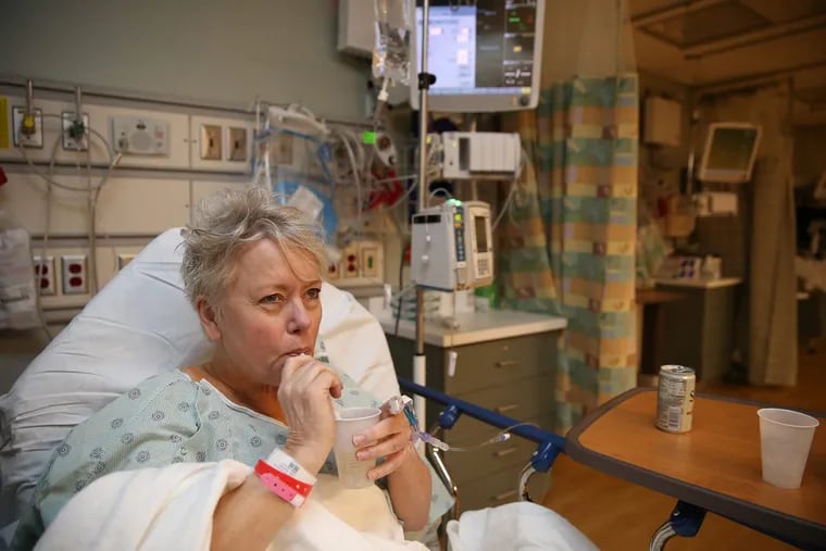 Patient Beth Thompson takes a drink after surgery at Cooper University Hospital. The hospital is reducing the use of intravenous fluids when possible.